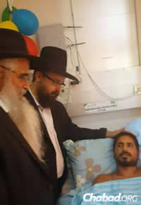 Rabbi Amitai Yemini, director of the Chabad Israel Center in Los Angeles, left, and Rabbi Menachem Kutner, director of Chabad Terror Victims Project visited last week with Mordechai Yemin, a wounded soldier (Photo: CTVP)