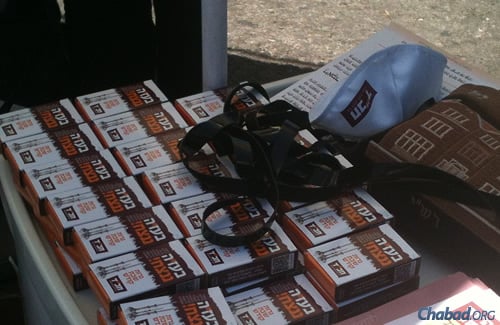 Hundreds of brochures a day with the ''With G-d's Help We Will Prevail'' theme are handed out daily in Jerusalem's Machane Yehuda open air market.