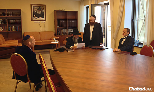 Rabbi Shmuel Kaminezki, chief rabbi of Dnepropetrovsk, prepares a ketubah together with the groom, seat at right, for a Jewish wedding taking place at Menorah Center.