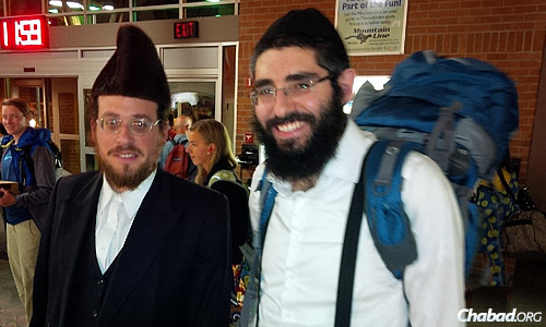 Rabbi Berry Nash, right, co-director of Chabad Lubavitch of Missoula, Mont., met mohel Moshe Roth at the airport in August when he arrived from New York to perform the brit milah for the Nashes' newborn son. Nash's father also flew in with a Torah lent out by the Beis Yisroel Torah Gemach in Brooklyn, N.Y., contained in the blue backpack.