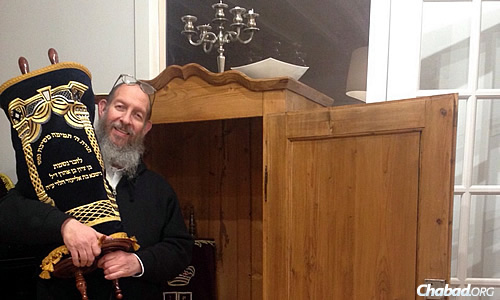 Chanowitz holds the small Torah named for the Israeli teens, which was sent to Chabad of the Big Island in Kailua Kona, Hawaii.