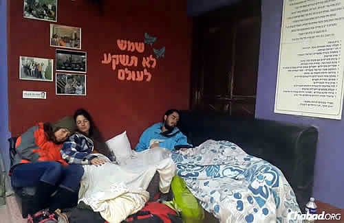 People make due at the Chabad House in Kathmandu, sleeping on couches, chairs, tables, mattresses on the floor—even outside on the ground.