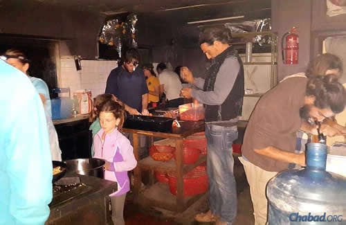 Making a meal out of scant items in the Chabad House kitchen. Food and water have been dwindling, though donations are coming into the country.