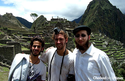Putting on tefillin at Machu Picchu in Peru. (Photo: Mordechai Lightstone)