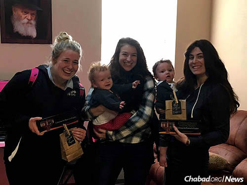 Margaret Butler, left, and Erin Horwitz at Chanukah time with menorah kits given by Rivky Gurevitch.