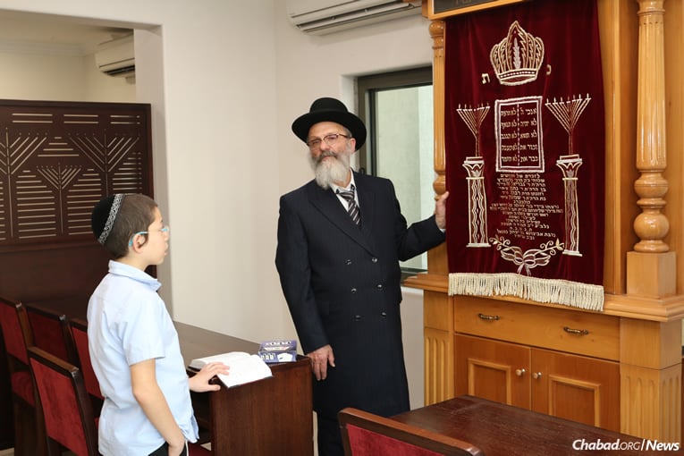 Moshe in the synagogue with his paternal grandfather, Rabbi Nachman Holtzberg. (Photo: Chabad of Mumbai / Chabad.org)