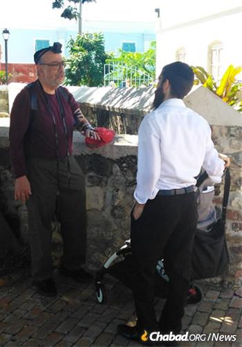 The rabbi helps a visitor with a mitzvah on the go.