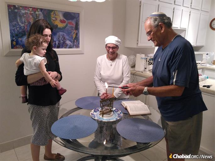 Eric and Penny Bowman enjoy a menorah-lighting and Chanukah celebration with the Chaikin family.