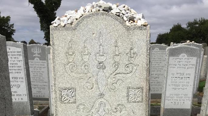The candelabra marks the grave of a pious Jewish woman.