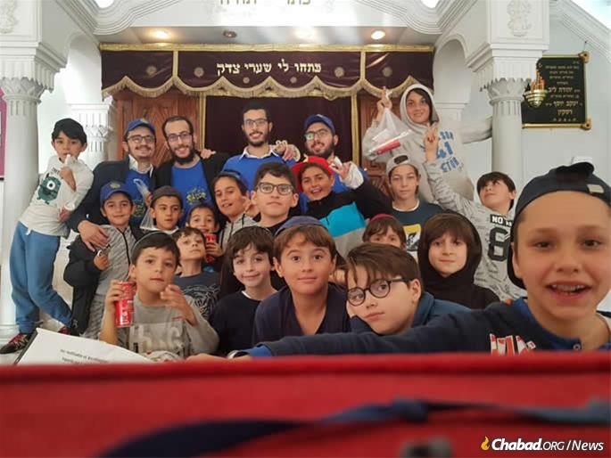 Children gather for an event in the Chabad synagogue. A plaque on the right honors the memory of Rabbi Leibel Raskin.