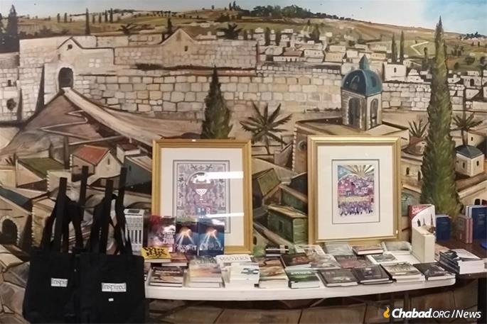 The deli is also serves as a Jewish bookstore, featuring a long table stacked with Jewish titles, with a mural of Jerusalem's Old City in the background.