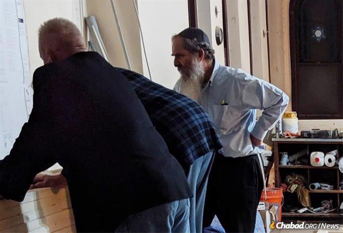 Rabbi Menachem Schmidt discusses the construction plans with the architect and builder.