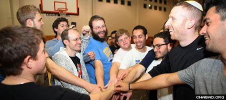 Rabbi Dovid Gurevich, center, of the Chabad House at UCLA and Jewish basketball player Tamir Goodman, second from right, party with Jewish students at the annual West Coast Jewish Student Summit.