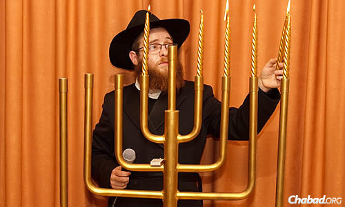 Rabbi Aryeh Schvartz lights the menorah during a Chanukah celebration at the Jewish community center in Donetsk.