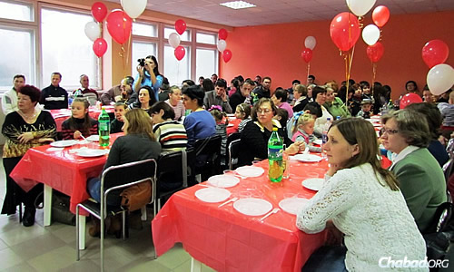 A Chanukah meal for families in Mariupol; its Jewish community, including a kindergarten and daily minyan at synagogue, continue to function despite the war.