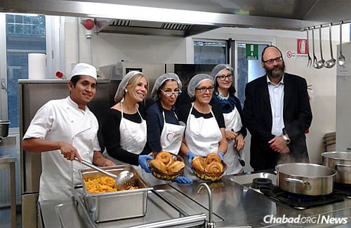 Meals are provided in Milan, Italy, to Eritrean, Ethiopian, Sudanese and Syrian refugees, many of them Muslim, who temporarily stay in rooms below the Milan central train station, these days retrofitted as a Holocaust memorial and museum. Some of the cooking staff and volunteers, shown with Rabbi Igal Hazan, who oversees the kitchen.